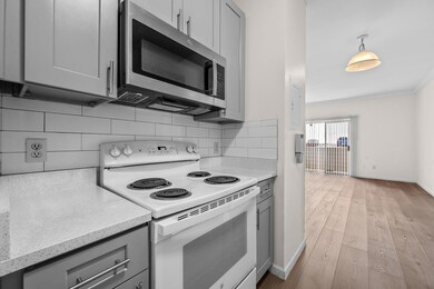 Kitchen with white electric range, stainless stee