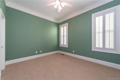 Bedroom 3 has neutral carpeting,heavy molding, lig