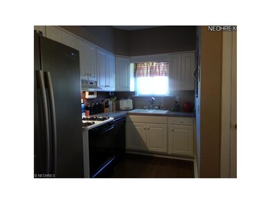 Generously sized kitchen, all appliances stay, with eat-in space BEHIND this photo, or make it your additional counter space, there's plenty of room. Wood laminate floor.    (more photos coming, the camera phone died)