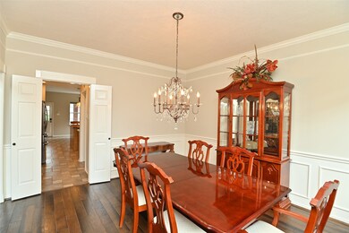 Dining room has wainscoting and crown molding.