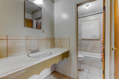 Full bath featuring tile patterned floors, toilet,