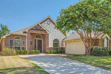View of front of house featuring a garage and a front lawn