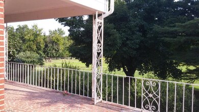 Front porch wraps around the side of the home. What a view!