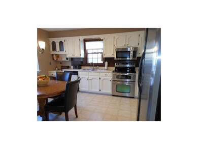 Kitchen has tile backsplash and newer stainless st