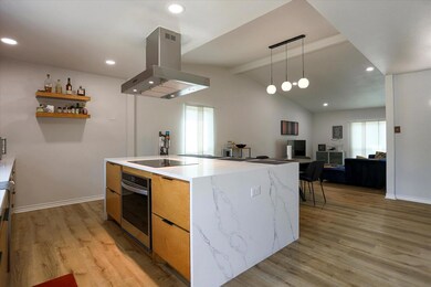 Kitchen featuring lofted ceiling with beams, light