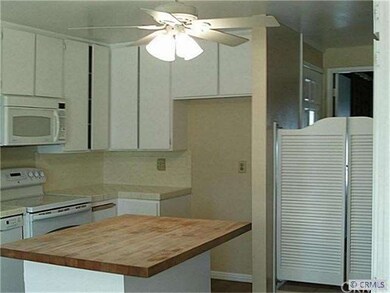 Open kitchen next to dining room w/shutters for pr