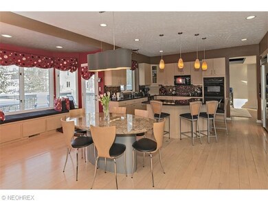 The kitchen boasts a sitting area, deck access, an
