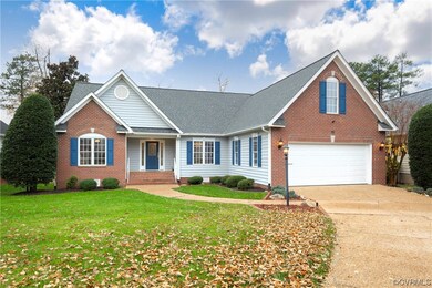 View of front facade with a garage and a front law