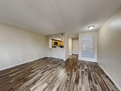 Unfurnished living room with a textured ceiling an