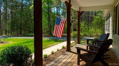 Wooden deck featuring a yard and a view of trees