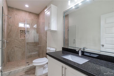 Full bath with vanity, a stall shower, and recessed lighting