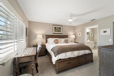 Bedroom featuring carpet, ceiling fan, multiple wi