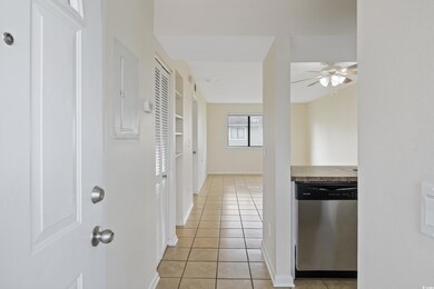 Corridor featuring light tile patterned floors