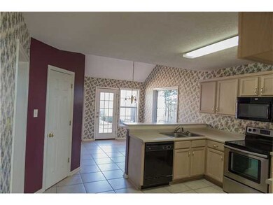 Open kitchen with breakfast bar and eat in area. T