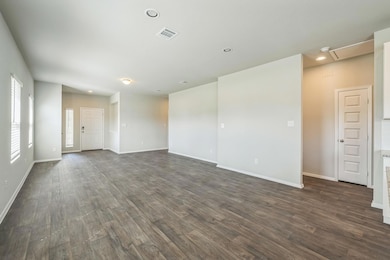 Spare room featuring dark wood-style flooring and