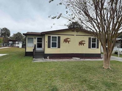 Manufactured / mobile home with entry steps and a front yard