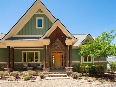 Beautiful stone work surrounds the attractive arts and craft styled front door.