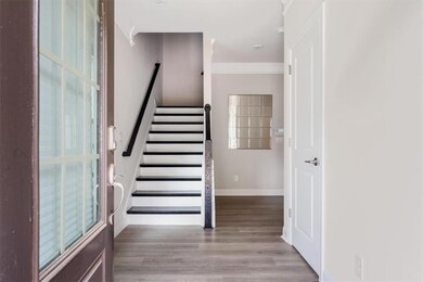 Staircase featuring crown molding, baseboards, and wood finished floors