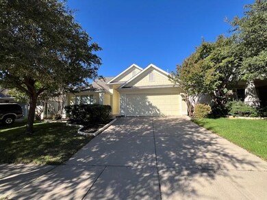 View of front of house with a front yard and a gar