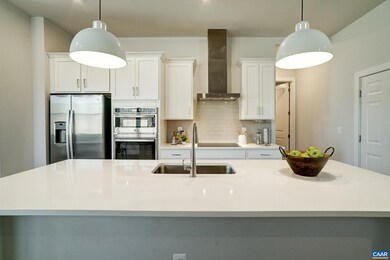 Large island with modern pendant lights seats 4!