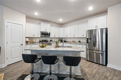 Kitchen with an island with sink, breakfast bar, r