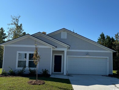 View of front of home with a garage and a front la