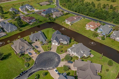 Aerial overview of property's location with a large body of water and nearby suburban area