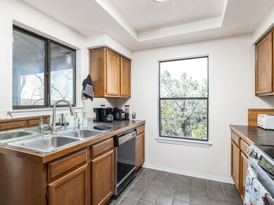 Kitchen with dark countertops, baseboards, dishwa