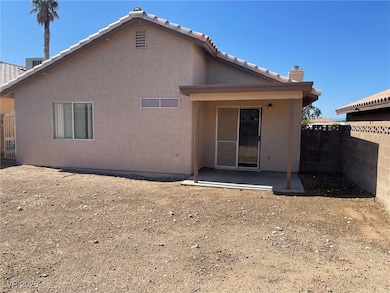 Rear view of house featuring a patio, stucco sidin