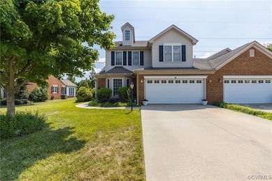 View of front of property featuring a garage and a front yard