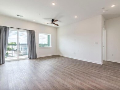 Empty room with a ceiling fan, wood finished floo