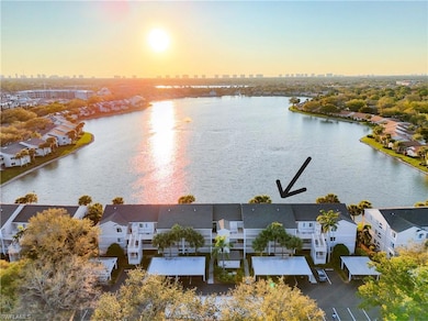 Aerial view of condo building on lake. Less than 4