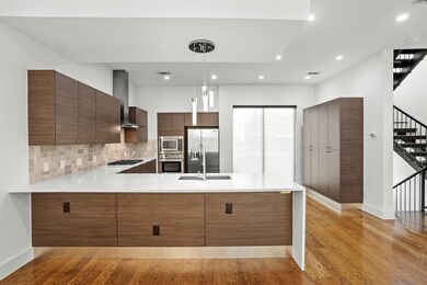 The kitchen features light counters, breakfast bar