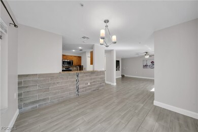 Unfurnished living room with a chandelier, a ceiling fan, light wood-style flooring, and recessed lighting