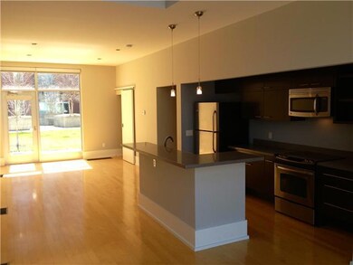 Living room opens to ground floor patio space.