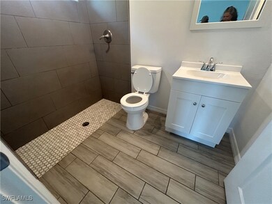 Full bath with vanity and a tile shower