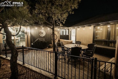 Patio at night featuring outdoor dining space