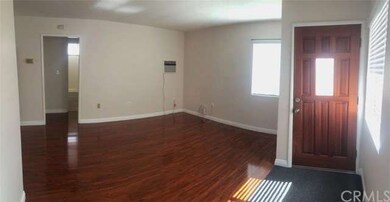 Living Room with laminated wood flooring, wall air