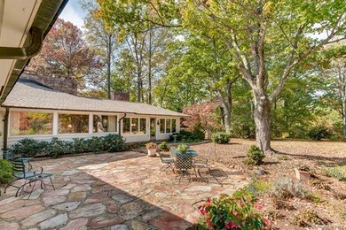 This home wraps around a large fieldstone terrace 