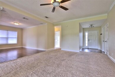Living Room showing Foyer to the right, Hallway to