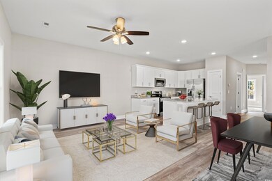 Living room featuring ceiling fan and light hardwo