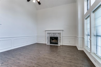 Formal living room featuring large windows and bea