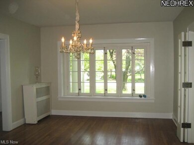 Large Formal Dining Room Features Hardwood Floors.
