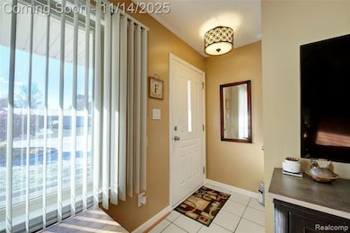 Entrance foyer with baseboards and light tile patterned floors