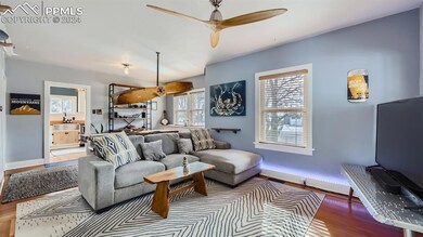 Living room featuring, ceiling fan, and hardwood /