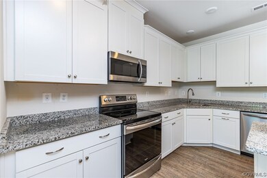 Kitchen with hardwood flooring, electric range ove