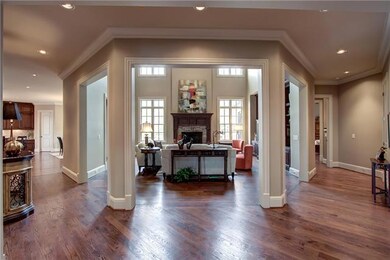 Open yet nestled between striking columns – this 2 story living area allows for many furniture configurations amongst luxury appointments. 