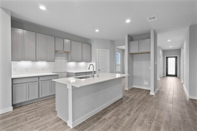 The open concept living room and kitchen makes for a great way to keep the party going and never miss a beat! Gather the family together in good conversation while preparing a fabulous meal in this breathtaking kitchen! Featuring high ceilings, light stained wood cabinets, quartz countertops, SS appliances, modern tile backsplash, recessed lighting, and kitchen island with ample counter space!