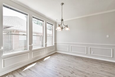 Formal Dining Room features crown, chair and picture molding, updated flooring and paint.