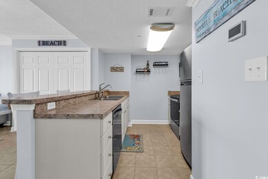Kitchen featuring a sink, dark countertops, visibl